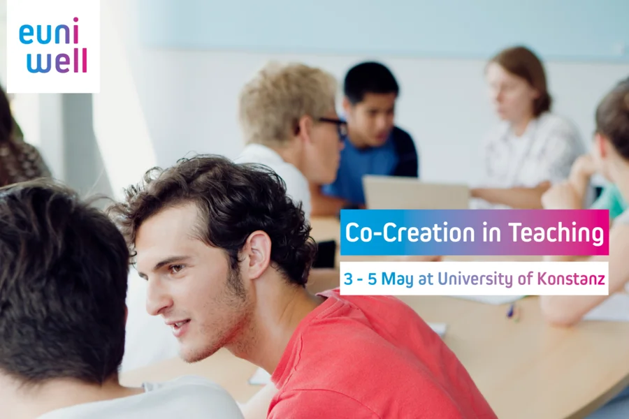 This image shows a group of students engaging in a discussion, likely within a classroom setting. The EUniWell logo is prominent, indicating a connection to the European University Alliance EUniWell. The text "Co-Creation in Teaching, 3 – 5 May at University of Konstanz" suggests an event focused on collaborative teaching methods, taking place at the University of Konstanz.
