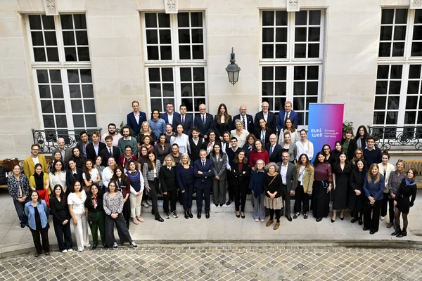 Group picture of the Rectors' Assembly attendees next to a EUniWell roll-up.