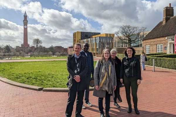 Participants of the staff exchange standing outdoors at the University of Birmingham.