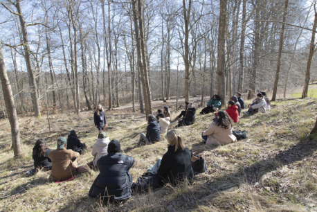 People sitting in a forest.