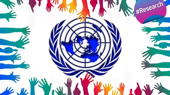The United Nations logo framed by a multitude of hands in the colours representing the SDG