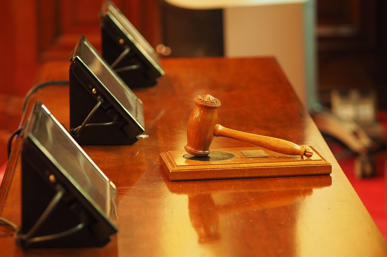 A gavel on a table in a courthouse